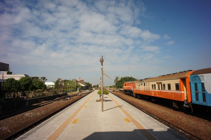 picture showing Platform of Fangliao Station with an orange train on the right.