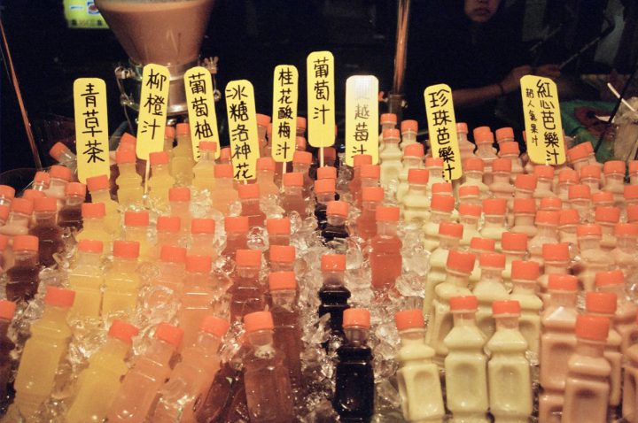 bottles of juice on ice in night market